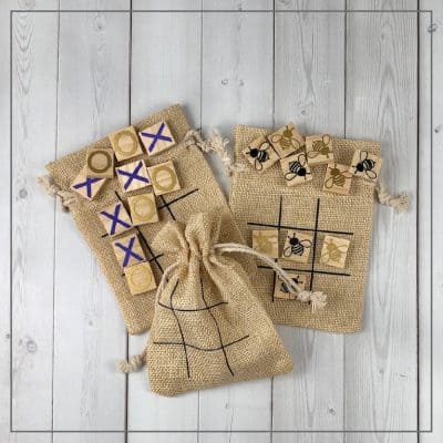 Tic tac toe boards on burlap bags on a white background.