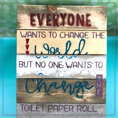 Wooden sign with toilet paper quote.