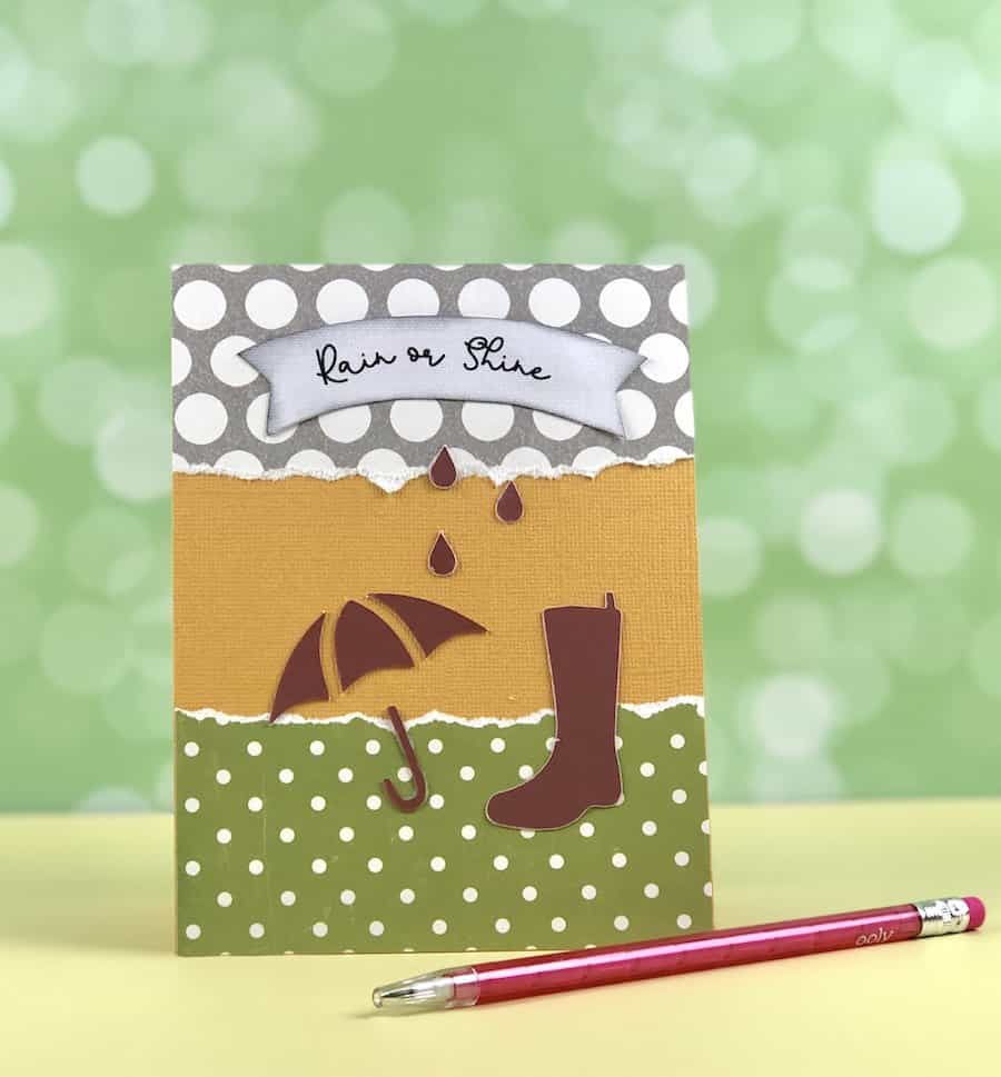 Make a greeting card sample with rain boot and umbrella.