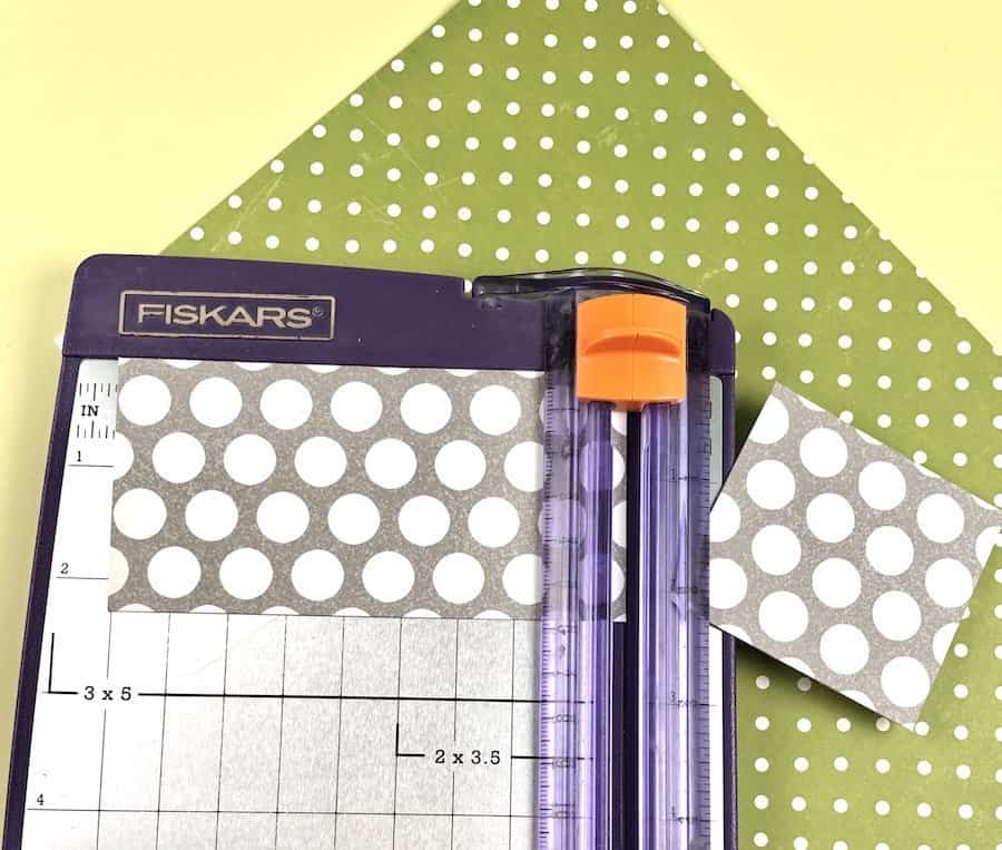 Paper cutter and grey polka dot scrapbook paper.