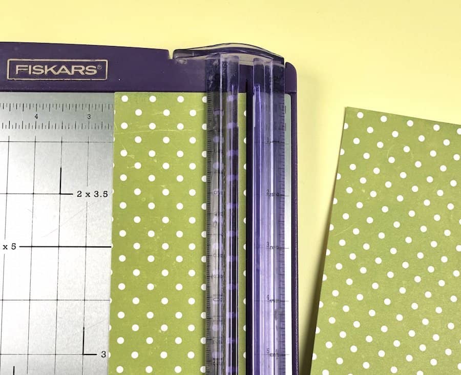 Paper cutter and green polka dot scrapbook paper.