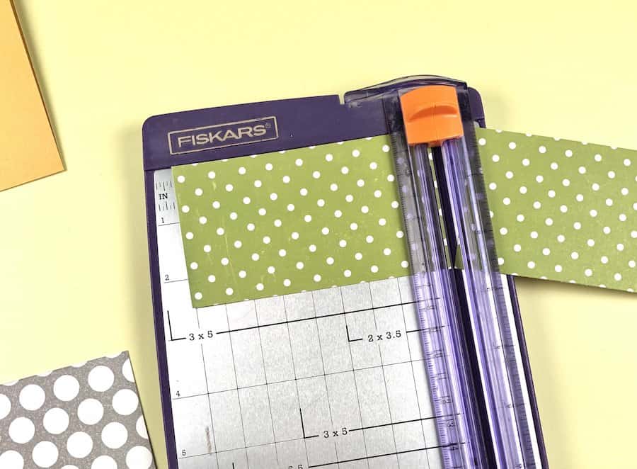 Make a greeting card with paper cutter and grey polka dot scrapbook paper.