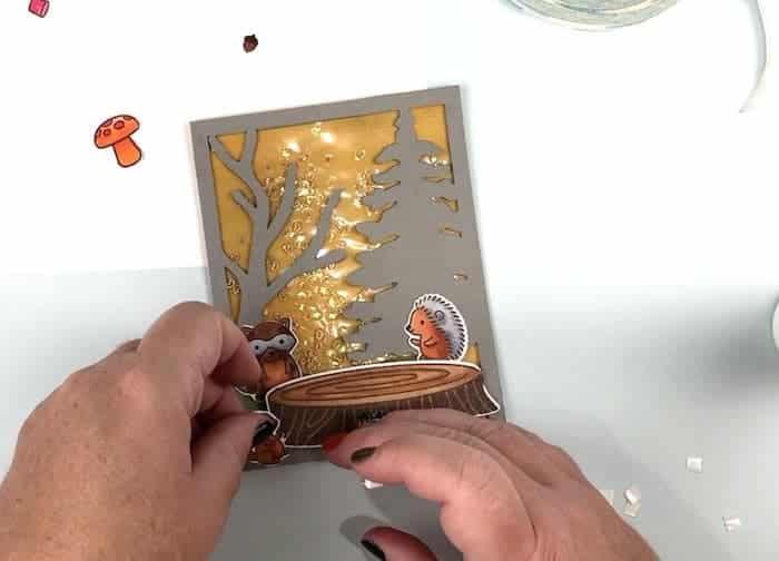 Arrange the forest animals on the card front with 3D foam dots.