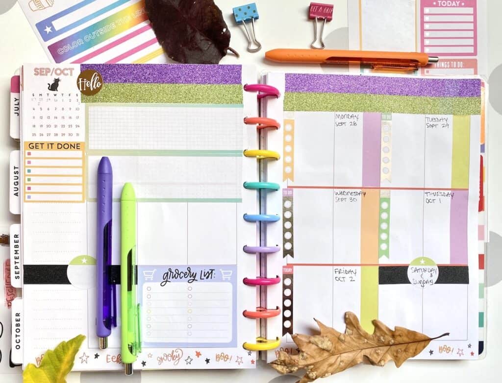 Planner covered pages with Washi tape and Happy Planner stickers.