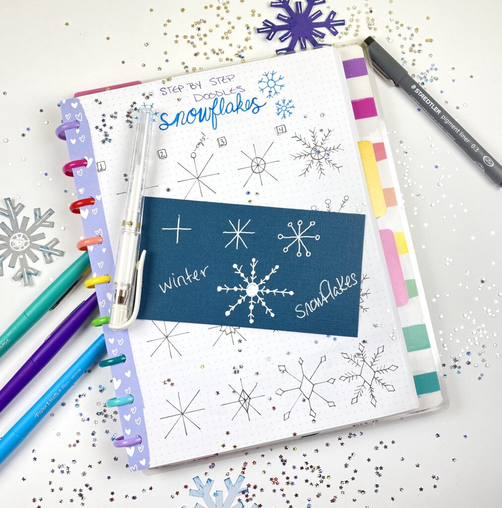 white gel pen snowflakes on darker cardstock paper