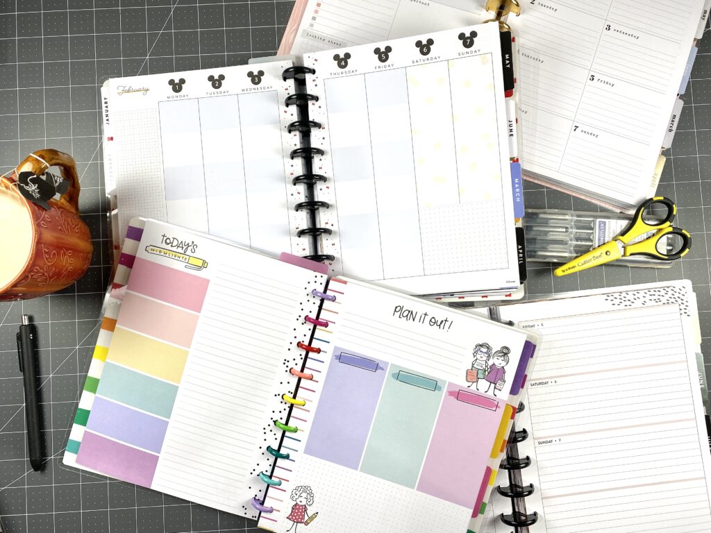 a pile of multiple happy planners to use at once in a frankenplanner