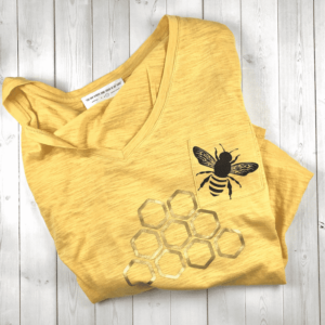 Yellow shirt with bee and honey comb.