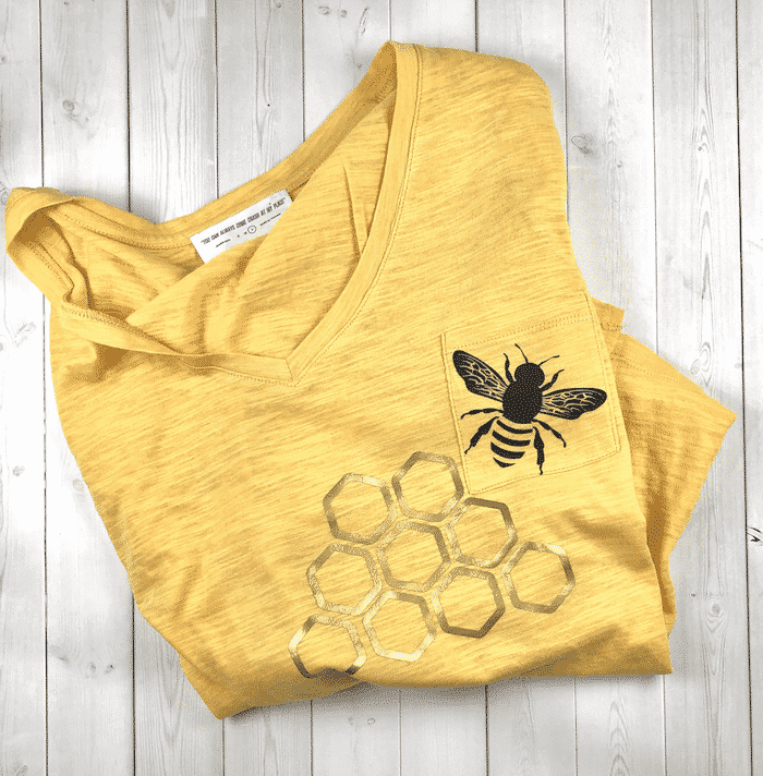 Yellow shirt with bee and honey comb.